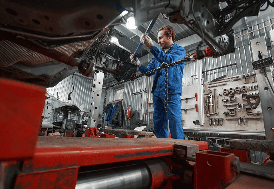 Technician working on driveshaft in machine shop